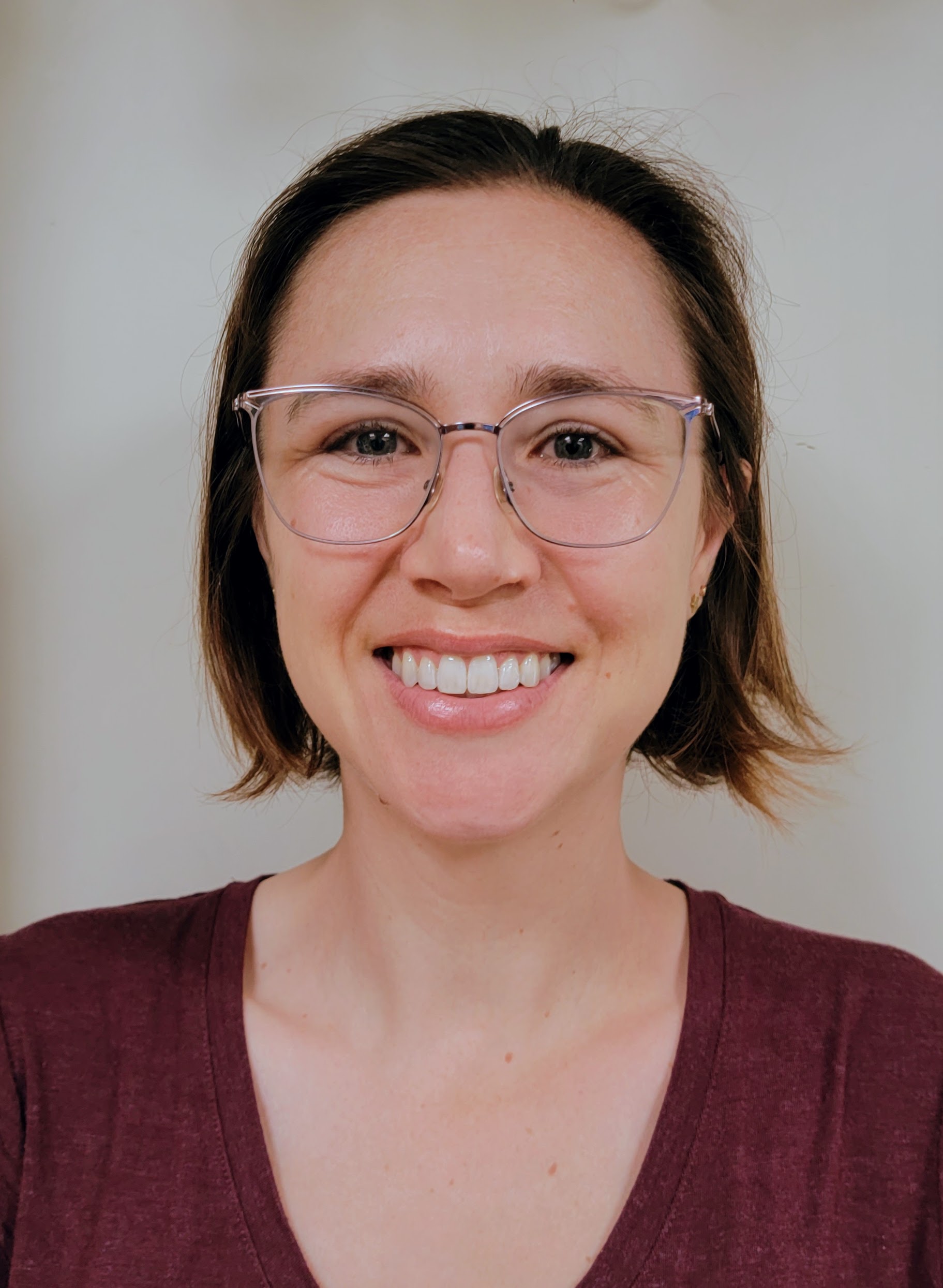portrait of Kristen Hornung, a white woman with short brown hair and glasses